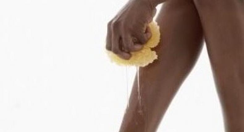 An African woman cleaning her feet