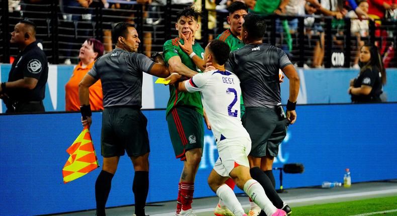 USA defender Sergio Dest shoves Mexico defender Gerardo Arteaga.USA TODAY Sports via Reuters Con
