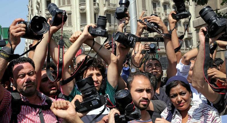 Egyptian journalists hold up their cameras outside the Egyptian Press Syndicate in downtown Cairo, Egypt April 28, 2016, during a protest against the interior minister following the arrest of colleagues for covering anti-government demonstrations. 