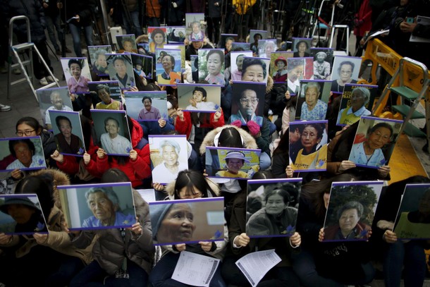 Students hold portraits of deceased former South Korean comfort women during a weekly anti-Japan r