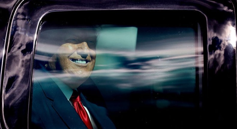 Donald Trump waves to supporters lined along on the route to his Mar-a-Lago estate in West Palm Beach, Florida, after his presidency.