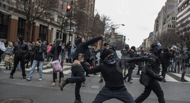 A rioter throws a rock during a protest on inauguration day, in Washington, Jan. 20, 2017. With far-right groups edging into the mainstream with the rise of President Donald Trump, self-described “anti-fascists and anarchists are vowing to confront them at every turn, and by any means necessary — including violence. 