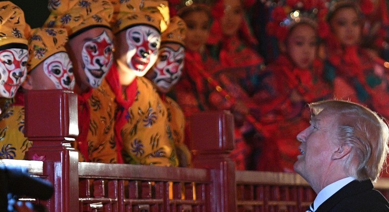 US President Donald Trump talks to opera performers at the Forbidden City in Beijing on November 8, 2017. US President Donald Trump toured the Forbidden City with Chinese leader Xi Jinping.