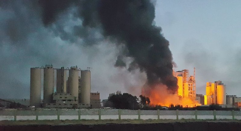 A fire next to the Libyan cement factory is seen during clashes between military forces loyal to Libya's eastern government, who are backed by the locals, and the Shura Council of Libyan Revolutionaries, an alliance of former anti-Gaddafi rebels, who have joined forces with the Islamist group Ansar al-Sharia, in Benghazi, Libya April 15, 2016. Picture taken April 15, 2016. REUTERS/Stringer        EDITORIAL USE ONLY. NO RESALES. NO ARCHIVE