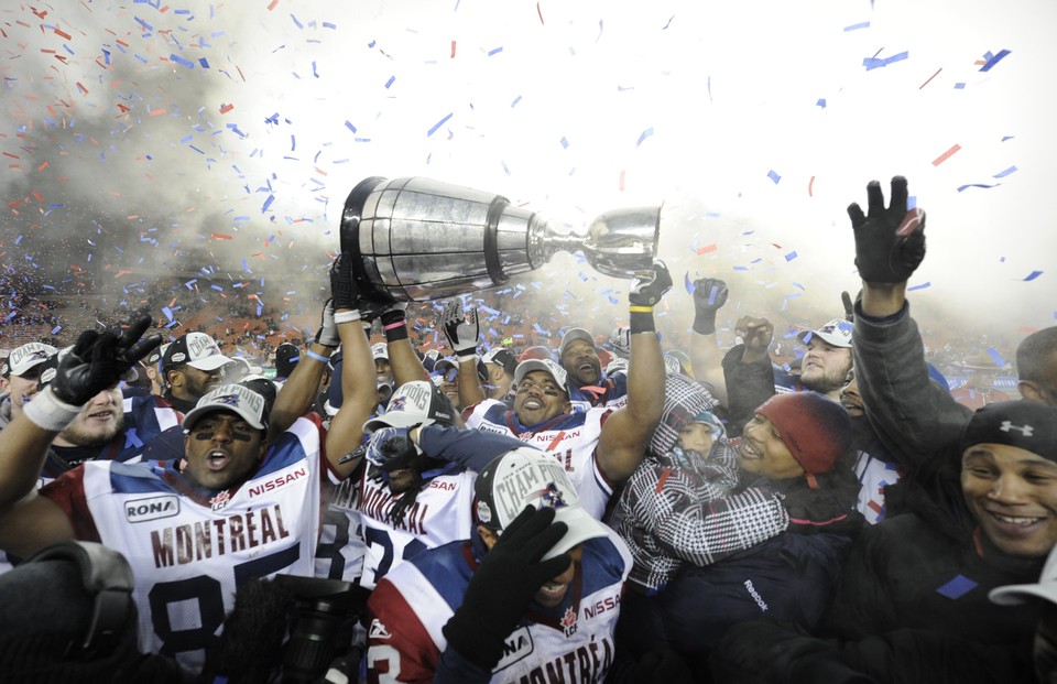 Alouettes players hold up the Grey Cup after defeating the Roughriders during the CFL's 98th Grey Cup football game in Edmonton