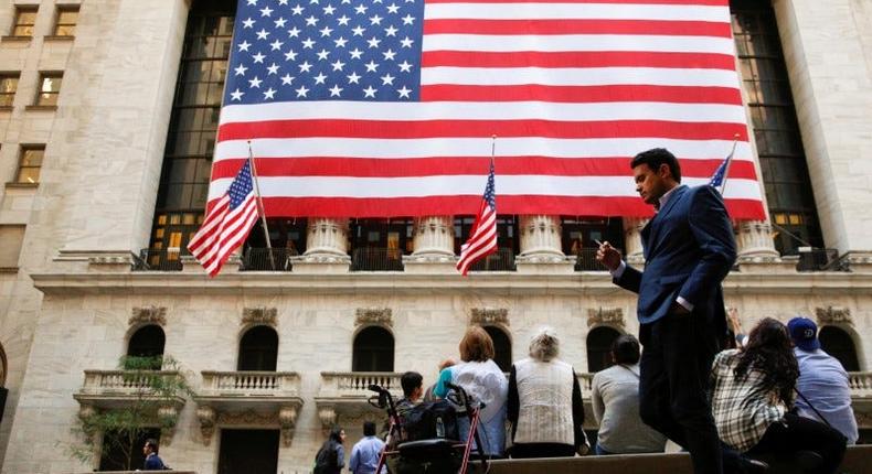 People sit outside the New York Stock Exchange (NYSE) in New York City, U.S., September 15, 2016.Brendan McDermid/Reuters