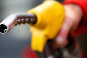FILE PHOTO: An attendant prepares to refuel a car at a petrol station in Rome