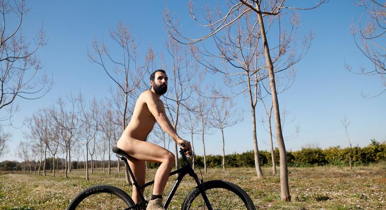 Alejandro Colomar poses naked on a bicycle in his vegetable garden, as Spanish court has ruled in favour of allowing him to continue walking around his village naked, as he has been doing since 2020, in Aldaia, near Valencia, Spain, February 3, 2023.REUTERS/Eva Manez