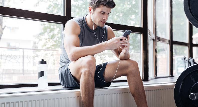 man on phone in gym