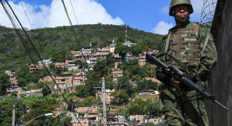 A soldier takes position at the Lins de Vasconcelos slum complex during a crackdown on crime gangs in Rio de Janeiro, Brazil, on August 5, 2017