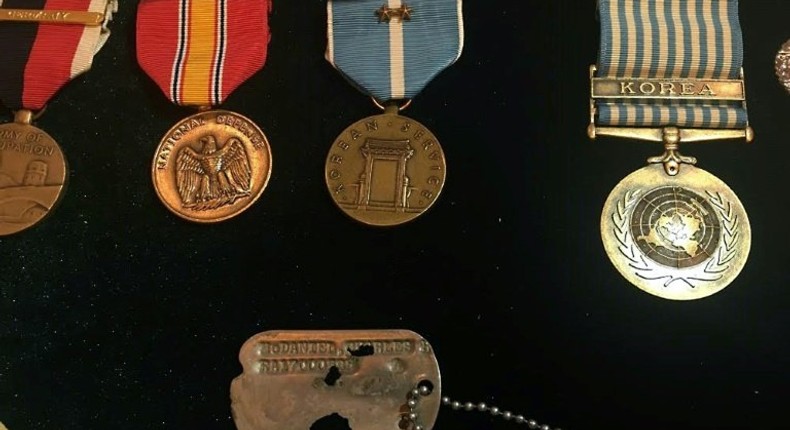 The identity tag and medals belonging to Army Master Sergeant Charles McDaniel, who went missing during the Korean War