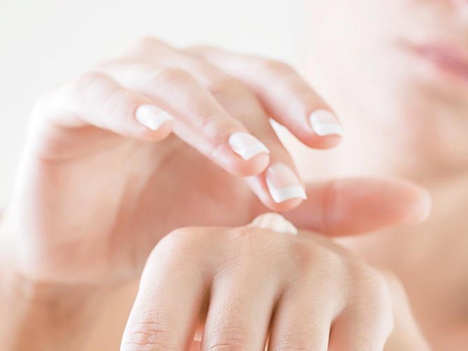 36034_stock-photo-female-applying-cream-to-her-hands-7072339shutterstock_7072339