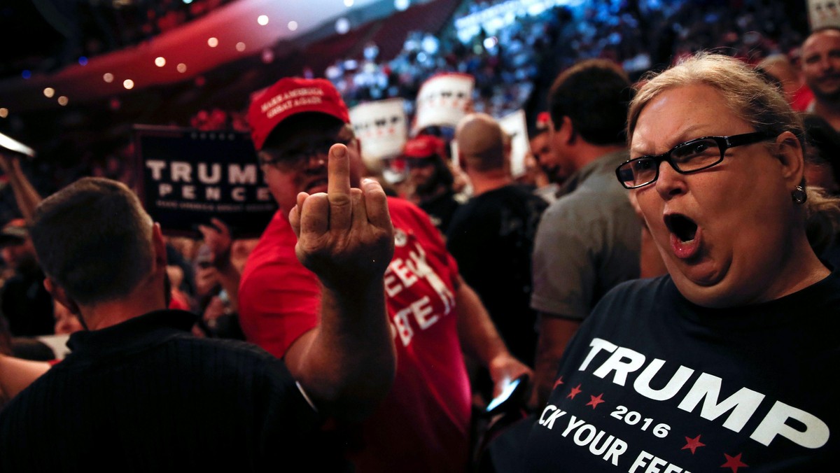 Supporters of Republican U.S. presidential nominee Donald Trump scream and gesture at members of the