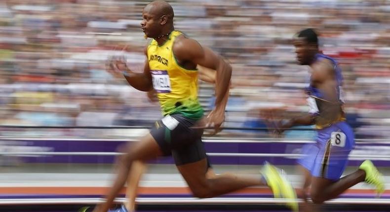 Asafa Powell of Jamaica runs on his way to winning his 100m heat round 1 during the London 2012 Olympic Games at the Olympic Stadium August 4, 2012.     REUTERS/Phil Noble