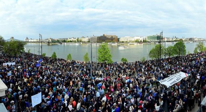 Tens of thousands demonstrated in Budapest against the controversial education legislation the day before it was signed, many chanting Don't sign it, Janos! and holding up placards reading Veto!