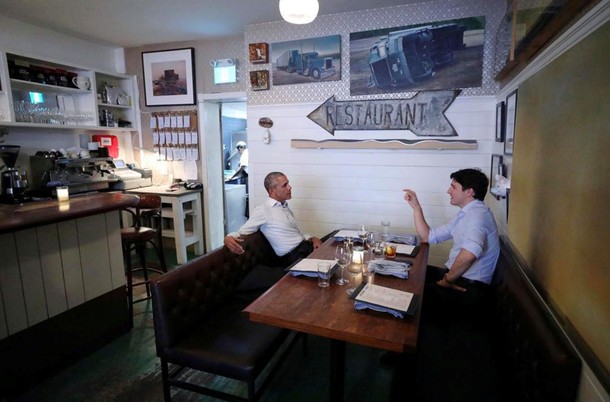 Canada's Prime Minister Justin Trudeau speaks with former United States President Barack Obama at a 