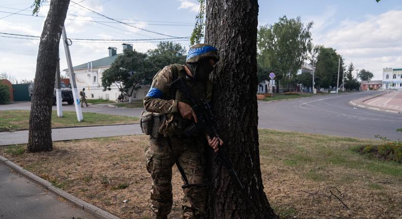 A Ukrainian soldier behind a tree after hearing the sound of a drone in the town center of Sudzha, Russia, on August 16, 2024.Taras Ibragimov/Suspilne Ukraine/JSC UA:PBC/Global Images Ukraine via Getty Images