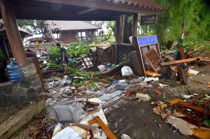 A man stands among ruins after a tsunami hit at Carita beach in Pandeglang, Banten province