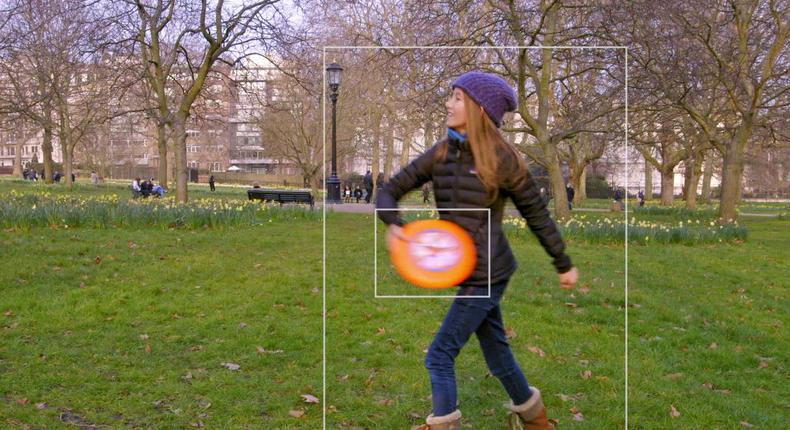 I think it's a young girl throwing an orange Frisbee in the park, Microsoft's AI will tell you.