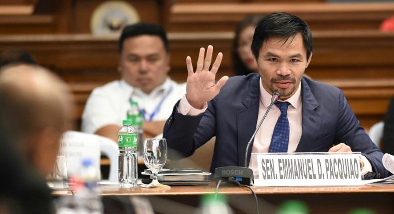 Manny Pacquiao (R) is juggling his boxing career with his role as a senator in the Philippines