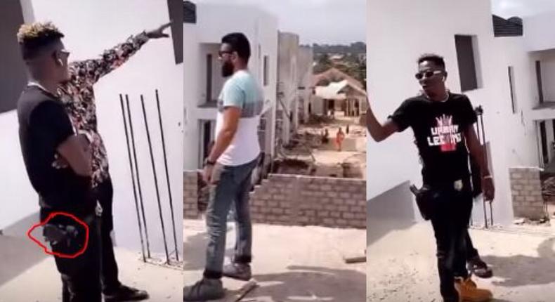 Shatta Wale strapped with a gun while inspecting his Kumasi mansion