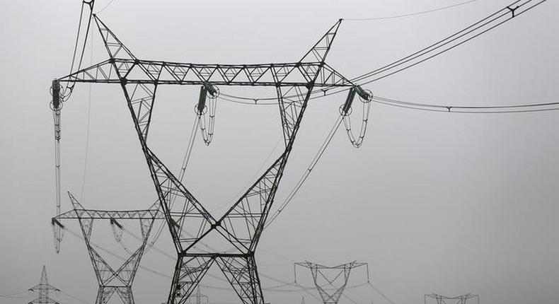 Electricity pylons and power transmission lines are seen at western desert road near Minya governorate, south of Cairo, on a hot and hazy day with temperatures reaching 48 degrees Celsius (116 Fahrenheit) May 27, 2015. REUTERS/Amr Abdallah Dalsh