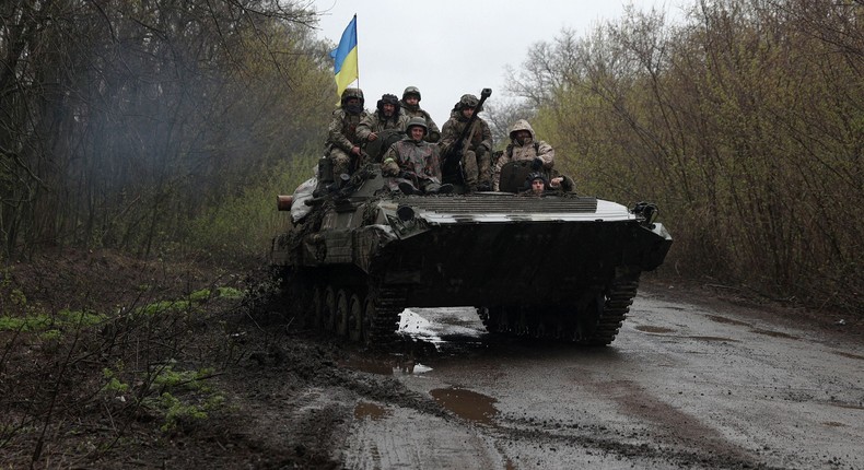 Ukrainian soldiers riding on an armored personnel carrier near Kharkiv.