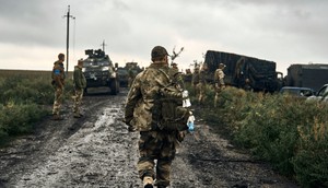 Ukrainian soldiers stand on the road in the freed territory of the Kharkiv region, Ukraine, Monday, Sept. 12, 2022.