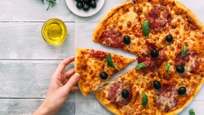 colorful tasty pizza. woman taking piece of italian pizza