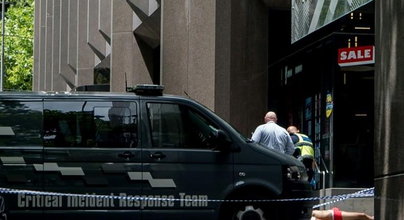 Police arrest a man (bottom-R) who allegedly drove a car into pedestrians in the centre of Melbourne on January 20, 2017