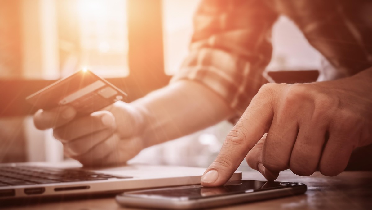 Online payment,Man's hands pointing smartphone and using credit card for online shopping.