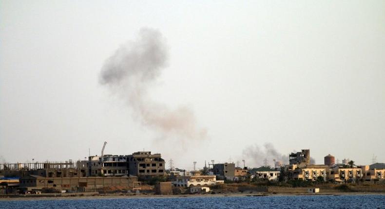 Smoke billows from buildings in the residential district of Gandoufa, in southwestern Benghazi, during clashes between Islamic State group's jihadists and the Libyan National Army