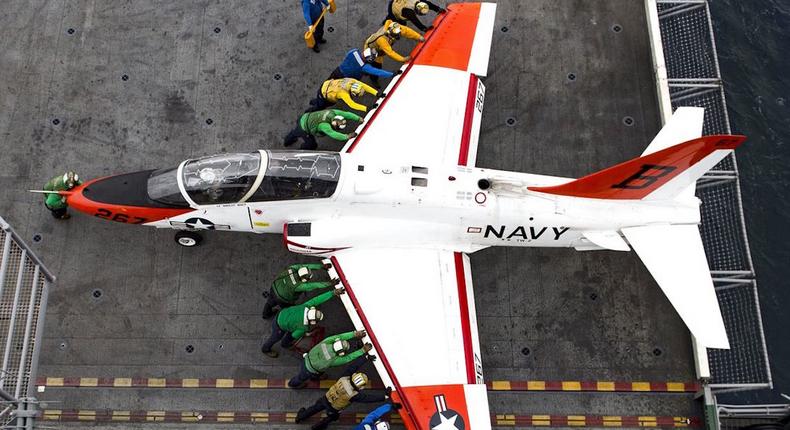 Sailors move a T-45C Goshawk aircraft on the flight deck of the aircraft carrier USS Dwight D. Eisenhower in the Atlantic Ocean, February 5, 2016. The Eisenhower was preparing for inspections and conducting carrier qualifications.