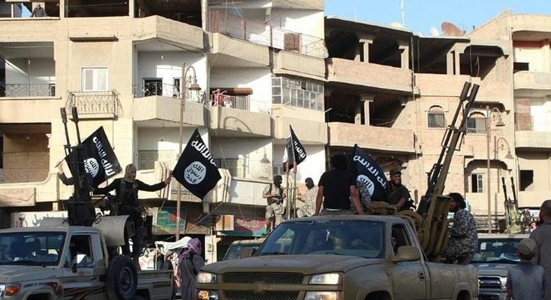 Islamic State jihadists parade through their de-facto capital in the northern Syrian city of Raqa in 2014