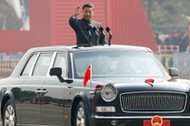 Chinese President Xi Jinping waves from a vehicle as he reviews the troops at a military parade marking the 70th founding anniversary of People's Republic of China