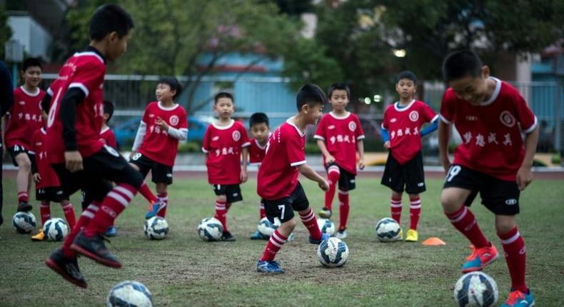 Children attend a football training session in the suburbs of Guangzhou in southern China's Guangdong province