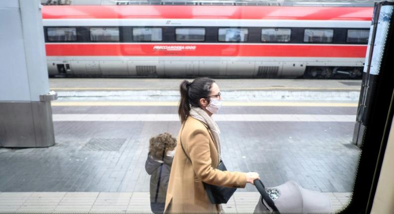 Passengers wear protective masks at Milan's main railway station following security measures taken in northern Italy against  the novel coronavirus. Milan is just north of the main centre of infection.