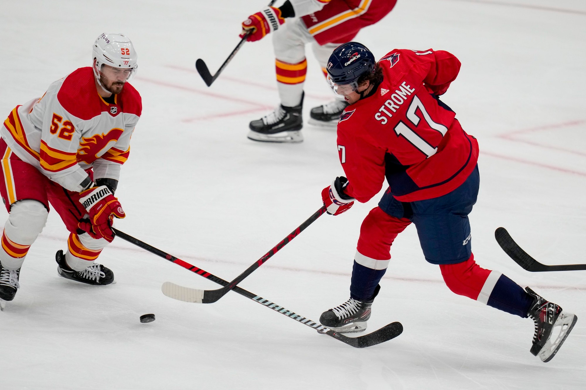 MacKenzie Weegar (Calgary Flames) a Dylan Strome (Washington Capitals).