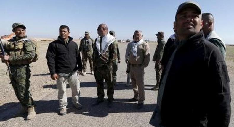 Head of the Badr Organisation Hadi al-Amiri (2nd R) stands with Shiite fighters during a military operation in the west of Samarra, in the desert of Anbar, March 7, 2016.