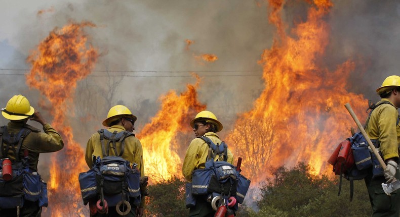 Firefighters attack the Camp Fire flames in Southern California.