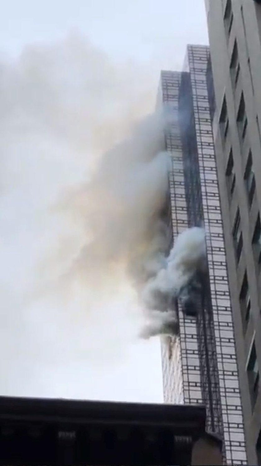 Damaged windows are seen after a fire in a residential unit at Trump Tower in New York