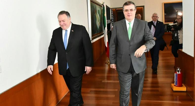 Mexico's Foreign Secretary Marcelo Ebrard (R) walks with US Secretary of State Mike Pompeo before a meeting in Mexico City that focused on slowing northward migration