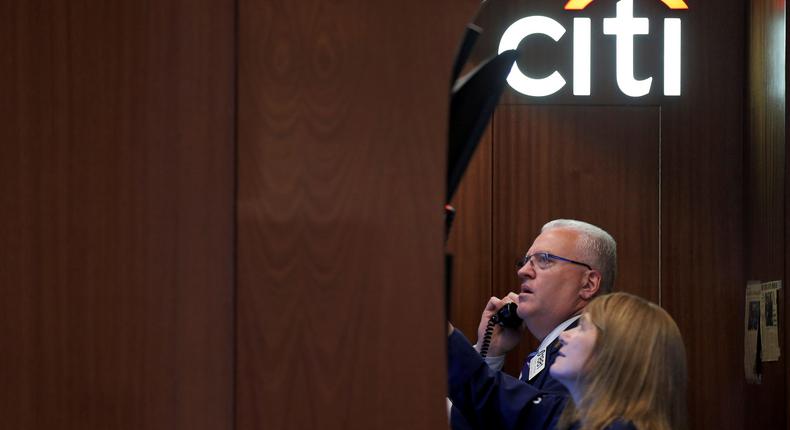 FILE PHOTO: Traders work in the Citigroup booth on the floor of the NYSE in New York
