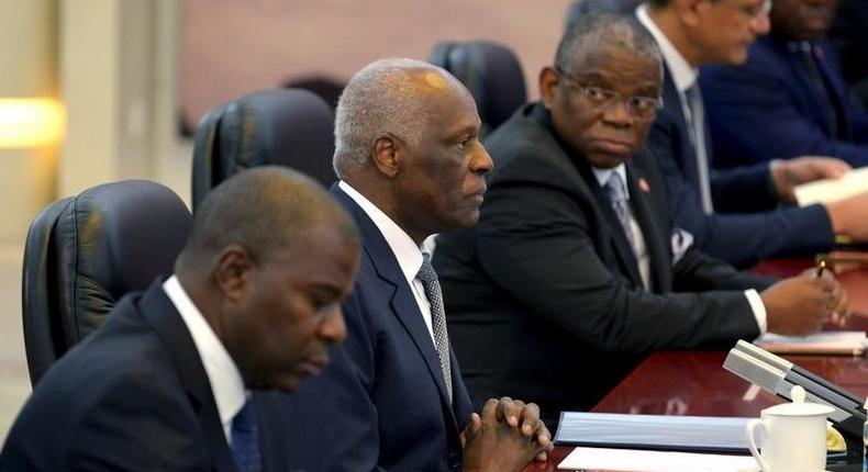 Angola's President Jose Eduardo dos Santos (C) listens to China's Premier Li Keqiang (not pictured) at the Great Hall of the People in Beijing, June 9, 2015. 