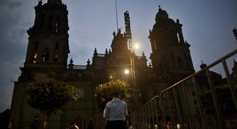 A priest is stabbed in the neck by a man identifying himself as a US national at the cathedral on El Zocalo square in Mexico City