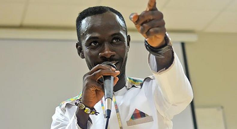 Okyeame Kwame with a microphone