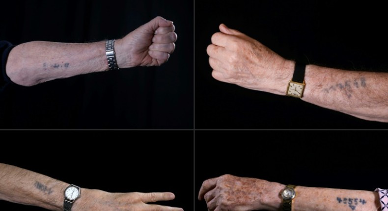 Holocaust survivors show Auschwitz prison numbers on their arms