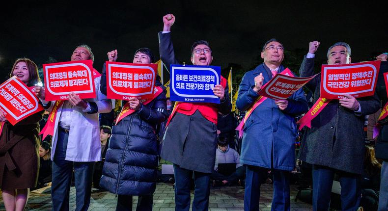 Doctors hold placards that read 'Opposition to the increase in medical schools' as they gather to protest against the government's plan to raise the annual enrolment quota at medical schools by 2000 in Seoul on February 15, 2024.Anthony Wallace/AFP/Getty Images