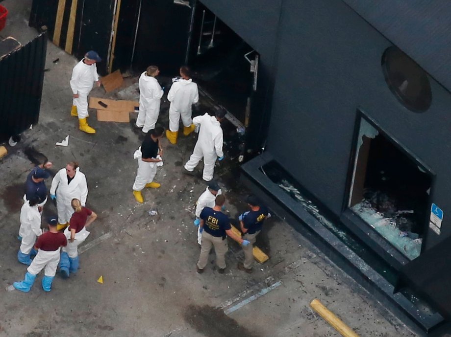 Police forensics investigators at the crime scene of the Pulse nightclub.