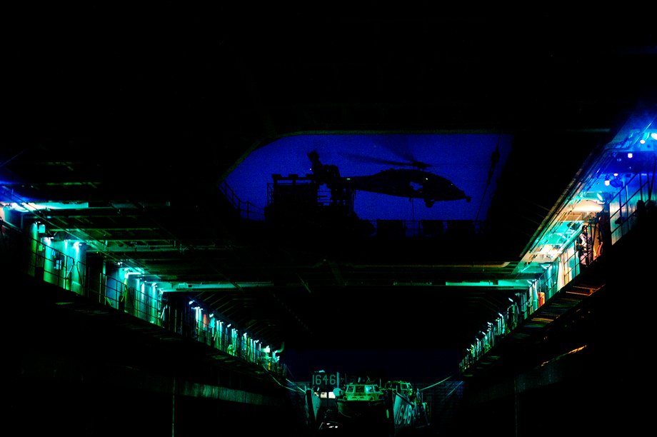 An SH-60 Sea Hawk helicopter is seen from the well deck of the amphibious dock landing ship USS Germantown as the ship transits the East China Sea.